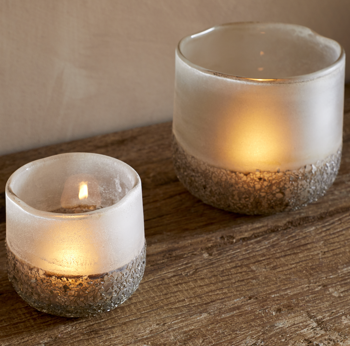 Riyara Recycled Glass Tealight Holder in Silver Sparkle by Nkuku styled and lit for a warm atmospheric effect.
