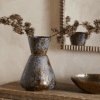 Brija Vase in Brown by Nkuku styled with flowers, featuring a rich reactive glaze and softly textured finish.