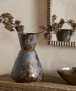 Brija Vase in Brown by Nkuku styled with flowers, featuring a rich reactive glaze and softly textured finish.