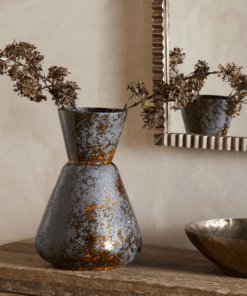 Brija Vase in Brown by Nkuku styled with flowers, featuring a rich reactive glaze and softly textured finish.