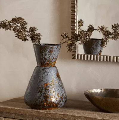 Brija Vase in Brown by Nkuku styled with flowers, featuring a rich reactive glaze and softly textured finish.