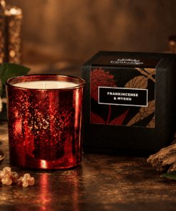 Frankincense & Myrrh Luxury Candle in ruby electroplated glass with branded gift box, styled with frankincense resin and warm woody accents.