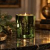Lit Frankincense & Myrrh Luxury Scented Candle in Limited Edition emerald electroplated glass, with a warm woody, sweet and musky fragrance.