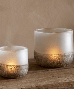 Riyara Recycled Glass Tealight Holder in Silver Sparkle by Nkuku styled and lit for a warm atmospheric effect.