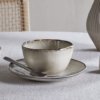 Nkuku Malia Breakfast Bowl in Cream, featuring a softly curved shape, fine vertical ribbed detailing, a warm cream glaze and a contrasting hand-finished brown rim.