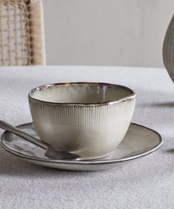 Nkuku Malia Breakfast Bowl in Cream, featuring a softly curved shape, fine vertical ribbed detailing, a warm cream glaze and a contrasting hand-finished brown rim.