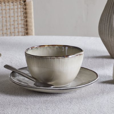 Nkuku Malia Breakfast Bowl in Cream, featuring a softly curved shape, fine vertical ribbed detailing, a warm cream glaze and a contrasting hand-finished brown rim.
