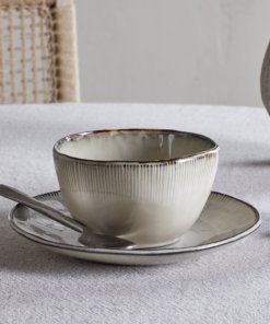 Nkuku Malia Breakfast Bowl in Cream, featuring a softly curved shape, fine vertical ribbed detailing, a warm cream glaze and a contrasting hand-finished brown rim.