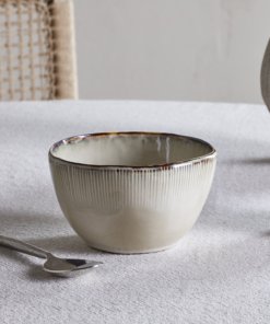 Nkuku Malia Breakfast Bowl in Cream, featuring a softly curved shape, fine vertical ribbed detailing, a warm cream glaze and a contrasting hand-finished brown rim.